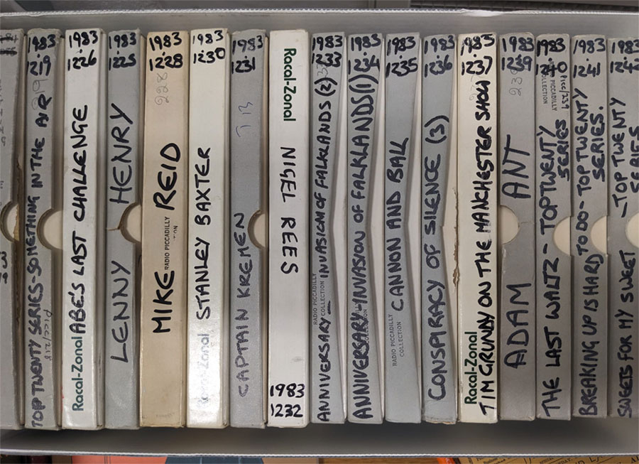 A box full of slim boxes with writing on them, housing radio show tapes